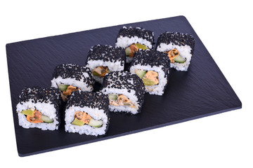 Traditional fresh japanese sushi rolls on a black stone Murugai on a white background. Roll ingredients: mussels, daikon radish, cucumber, spicy sauce, nori, rice, black sesame.