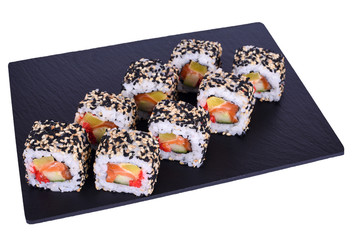 Traditional fresh japanese sushi rolls on a black stone Kyoto on a white background. Roll ingredients: salmon, daikon radish, cucumber, red tobiko, spicy sauce, nori, rice, sesame mix.