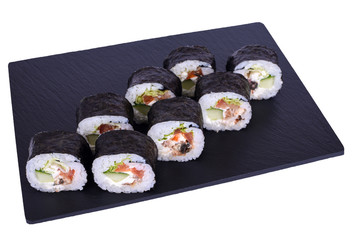 Traditional fresh japanese sushi futomaki on black stone Futomaki Unagi on a white background. Roll ingredients: eel, philadelphia cheese, cucumber, tomato, lettuce, nori, rice.