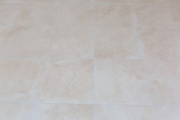 Naklejka premium Brown ceramic floor tiles closeup texture