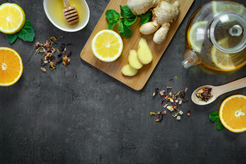 Ginger drink with lemon and mint on dark background. Top view, flat lay, copy space