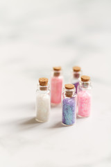 small jars with sequins for artwork on a light background