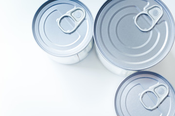 Top view of silver tin cans closed on white background
