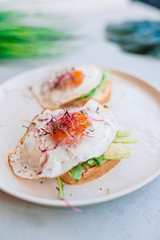 Healthy food concept. Tasty sandwich with avocado and fried eggs