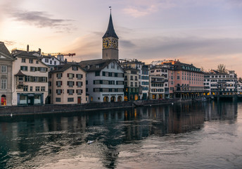 Fototapeta na wymiar View of the riverside of the Limmat and the deserted old town of Zurich during the Coronavirus lockdown at sunset