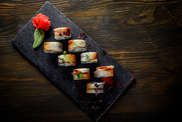 sushi roll with cream cheese and eel in plate on wooden table background