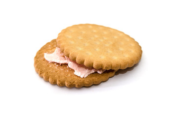 sandwich cookies on a white background. Tasty cracker with pink cream close-up.