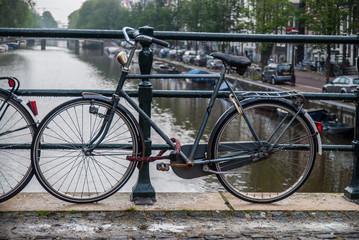 Fototapeta na wymiar bicycle chained to bridge in Amsterdam