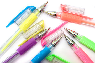 multi-colored pens on a white background. Close-up.