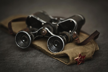 Military cap and vintage binoculars. Symbol of victory on may 9. Second world war