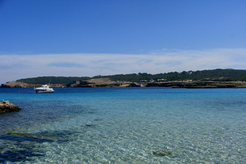 Deserted beach with turquoise waters, bright day