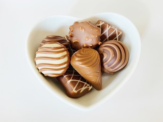 chocolate on heart cup on white background