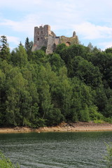  Castle on a rock by the lake - obrazy, fototapety, plakaty