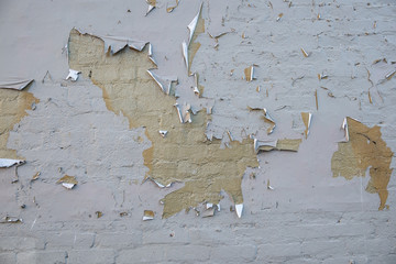 Peeling paint on brick wall