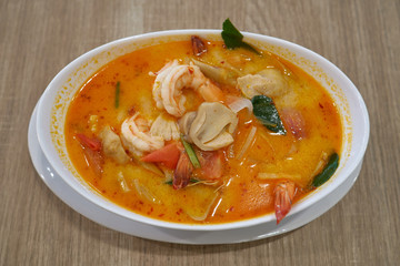 Closeup of a hot Tom Yam Goon soup with shrimps in thai restaurant in Bangkok, Thailand.