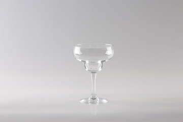 transparent Margarita glass on a light background in the Studio.