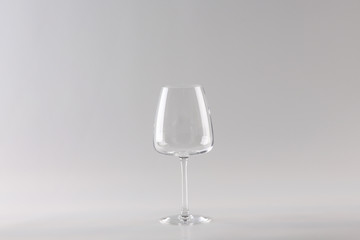 empty transparent white wine glass on a light background.