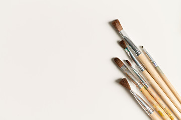 close-up of a paintbrush on a white background with space for writing. artist's composition