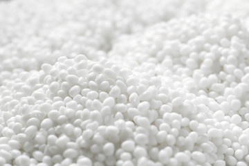Fototapeta na wymiar Closeup of a lot of granules of white plastic polymer
