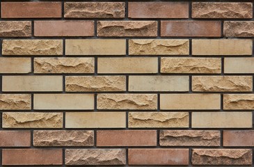 Brick wall of multi-colored bricks