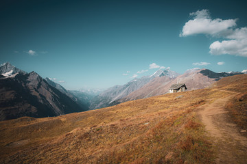 Fototapeta premium Stone church near path to the Matternhorn peak with snowy swiss Alps