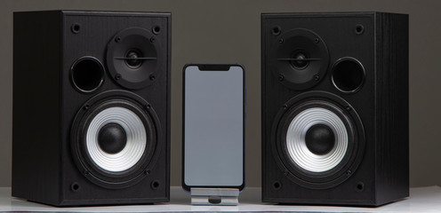 speaker with smartphone on grey background