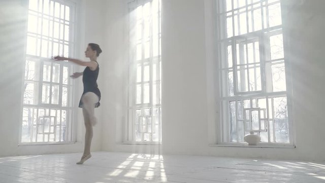Young ballerina dancing and whirling around herself.