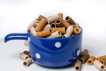 Tri-color pasta in a ceramic cup