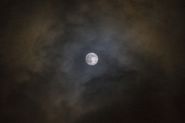 Mysterious moon in the cloudy sky.