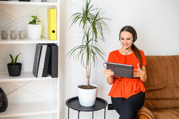 Young woman with hands free headset and tablet