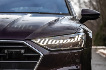 Laser and matrix headlights of a premium car. Close-up.