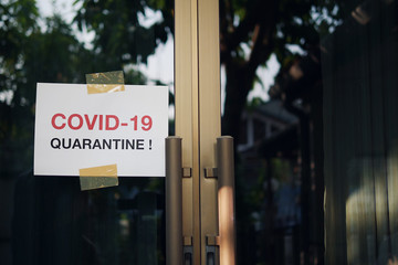 Self quarantine door sign due to novel Coronavirus COVID-19 pandemic, warning texts on white paper stick on home front door in self isolation time to stay at home  for virus protection and prevention.