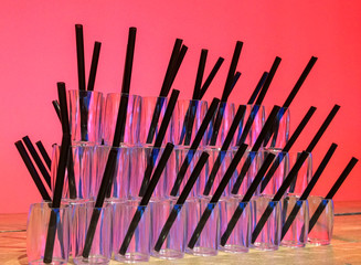 Cocktail glasses in front of a pink background
