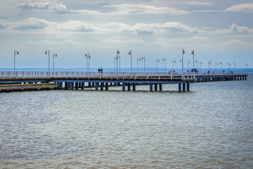 Fototapeta premium Wooden pier in Jastarnia village over Bay of Puck on Hel Peninsula, Poland