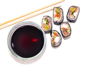 Keto diet. Rolls of cabbage, cucumber and red fish. Chopsticks and Soy Sauce