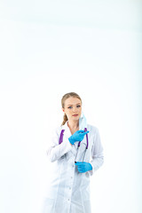 Fototapeta premium doctor nurse puts on a protective mask. A nurse in a respiratory mask. Put on masks. Wear gloves. beautiful blonde doctor shows how to put on a protective respiratory mask isolated on a white backgrou