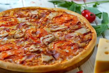 pizza with sausage, mushrooms and tomatoes