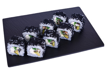 Traditional fresh japanese sushi rolls on a black stone Murugai on a white background. Roll ingredients: algae hiyashi, nori, rice, avocado, izumai perch, philadelphia cheese.
