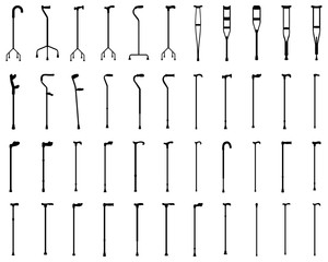 Black silhouettes of walking sticks and crutches on a white background