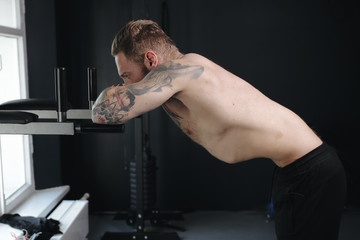 Fototapeta na wymiar fitness trainer doing abdominal vacuum exercise
