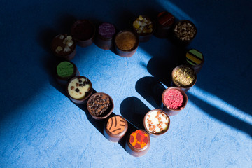 Various of sweet confectionery with chocolate candies and pralines. Handmade box of chocolates. Realistic chocolate set, delicious dessert pattern.