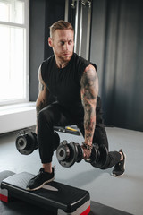 fitness coach squats exercising with dumbbells 