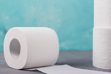 toilet paper rolls on a turquoise background
