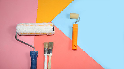 Repair tools on a multi-colored painted background. Shop banner, geometry. Minimal renovation and...