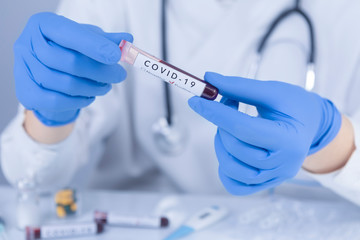Doctor hands analyzing Coronavirus COVID 19 test blood