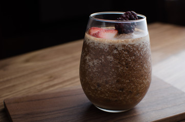 a glass of milk on a wooden table
