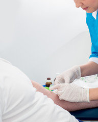 Obraz premium nurse is vaccinating the patient. Blood sampling from a vein in a medical laboratory