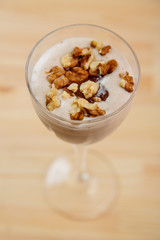 Glasses with ready smoothie chocolate ice cream banana smoothie and nuts.
