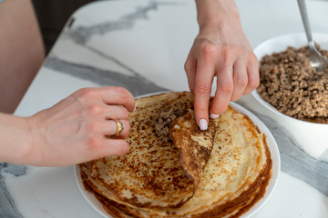 cooking delicious pancakes with meat filling