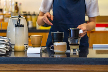 Waiter serving Vietnamese condensed milk coffee- Ca Phe Sua Da
